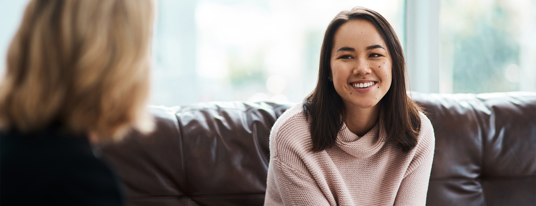 Therapy, happy women have a conversation on sofa and speaking or talking with a psychologist.