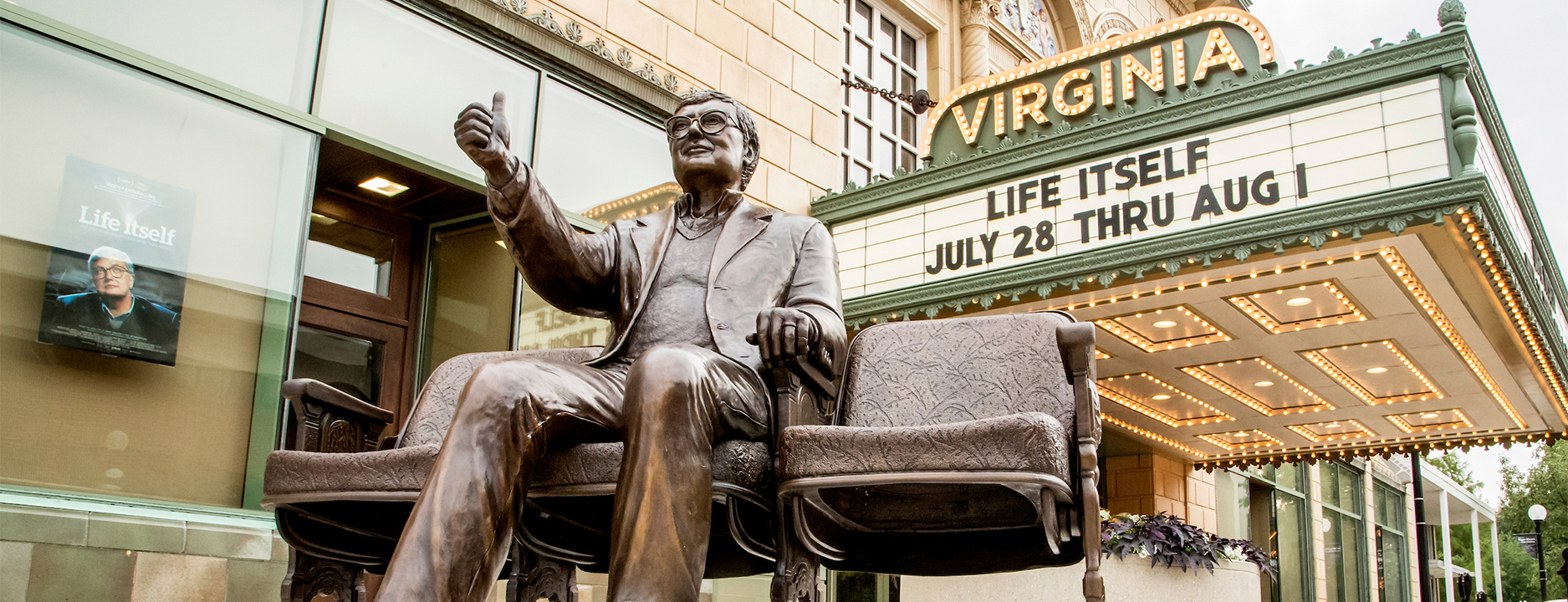 The Roger Ebert statue giving a thumbs up outside of the Virginia Theatre